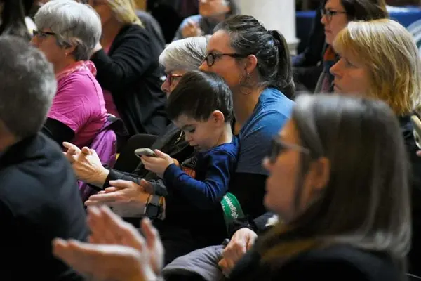 A mother holds her child as she listens to Dr. Caitlin Bernard speak at the Reproductive Health and Access Coalition Lobby Day on Thursday at the Indiana Statehouse. (Photo/Schyler Altherr of TheStatehouseFile.c0m)