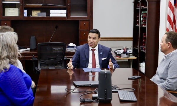 Indiana Secretary of State Diego Morales, center, meets with Scott County leaders in February 2025. (Photo from Morales’ official X account)