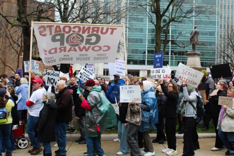 Protestors marched around the Indiana Statehouse holding signs saying “No one is above the law” and “Dump Trump” at the Hands Off! rally on Saturday, March 5. Many protestors cited their anger over the Trump administration’s targeting of government agencies, diversity, LGBTQ rights and immigration. (Photo/Farrah Anderson of WFYI)