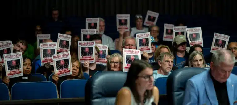 Audience members displayed signs mocking Marion County Sheriff Kerry Forestal on Sept. 3, 2025, during the City-County Council’s Public Safety and Criminal Justice Committee meeting where his department presented its 2026 budget at the City-County Building. Forestal was heavily criticized for his failure to meet with members of the public. (Photo/Doug McSchooler for Mirror Indy)