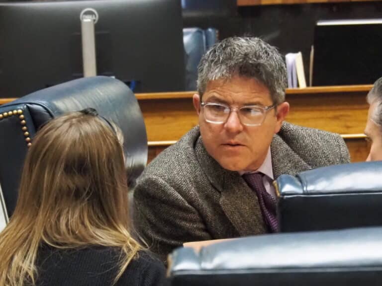 Senate President Pro Tempore Rodric Bray speaks with a fiscal analyst and a colleague from his seat in the Senate chamber on Monday, April 7, 2025. (Photo/Leslie Bonilla Muñiz of the Indiana Capital Chronicle)