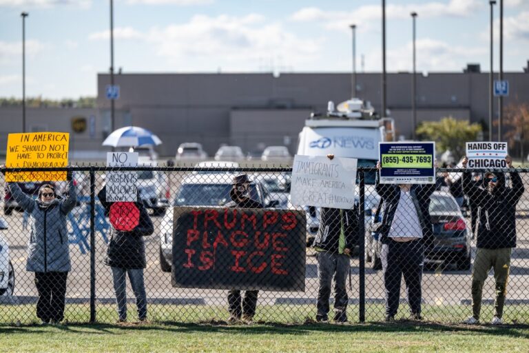 Protesters line the fence along Airport Road outside Gary/Chicago International Airport on Thursday. Department of Homeland Security Secretary Kristi Noem was joined by Gov. Mike Braun for a press conference at the airport discussing “Operation Midway Blitz.” (Photo/Javonte Anderson of Capital B)