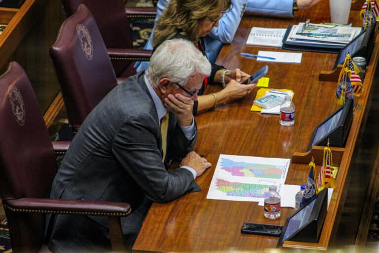 Rep. Greg Steuerwald, R-Avon, who authored the 2021 bill that established Indiana’s current congressional districts, compared maps during Monday’s House session. (Photo/Sydney Byerly of The Indiana Citizen)