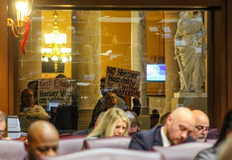 A handful of protesters stood outside the Indiana House chamber while lawmakers debated proposed amendments to the redistricting bill on Dec. 4. (Photo/Sydney Byerly of The Indiana Citizen)