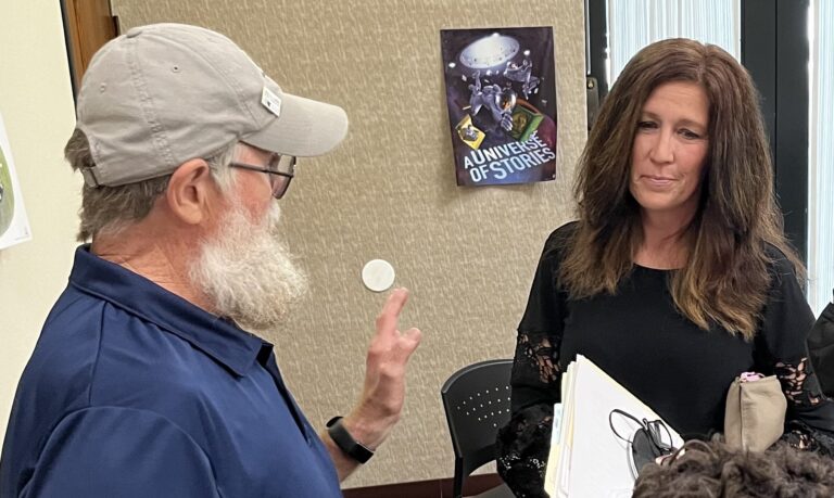 Former Fairfield Township Trustee Taletha Coles talks with board member Perry Schnarr after a contentious 2022 township board meeting. (Photo/Dave Bangert of Based in Lafayette)