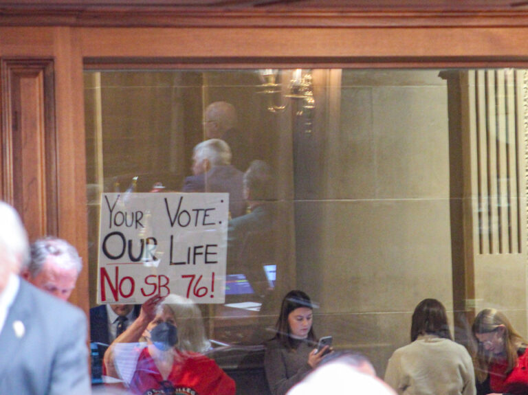 A small group of protestors stood outside of the Indiana House chamber on Tuesday afternoon in protest of Senate Bill 76. (Photo/Sydney Byerly)