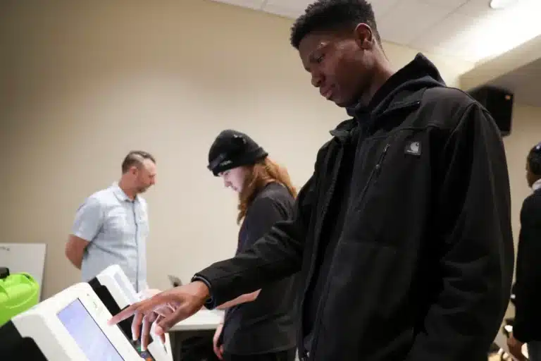 Cayden Crawford (right) casts his ballot during a mock vote hosted by the Marion County Election Board and the League of Women Voters at Warren Central High School in Indianapolis. (Photo/Jerod Ringwald for Mirror Indy)