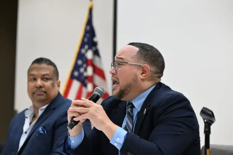 State Sen. Mark Spencer, D-Gary, spoke during a legislative town hall in Gary while state Rep. Earl Harris Jr., D-East Chicago, listened beside him as lawmakers discuss policies passed during the 2026 Indiana General Assembly session. (Photo/Javonte Anderson of Capital B)