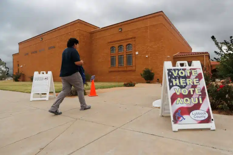 A voter walks past an election sign on his way to vote outside of the Lauro Cavazos Middle School polling station in Lubbock, Texas, on Tuesday, Nov. 8, 2022. Department of Homeland Security officials this week told the Lubbock County elections administrator to expect subpoenas for county voter records soon. (Photo/Mark Rogers for The Texas Tribune)